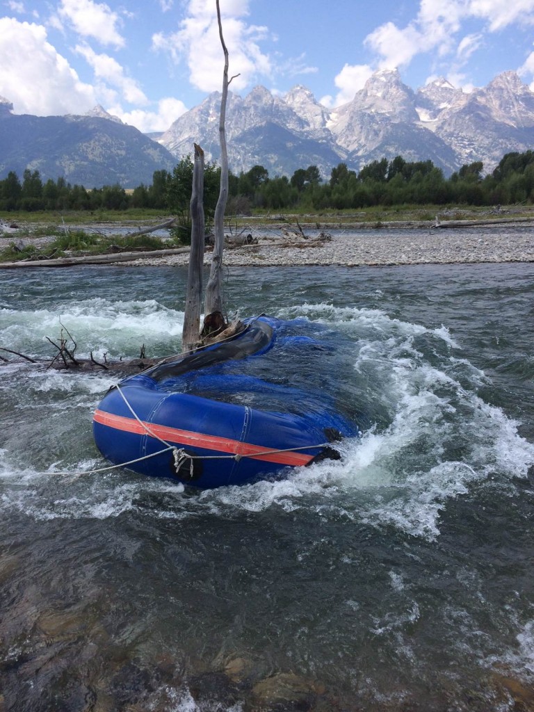 A raft hung up on a snag in the Snake River near Bar BC Ranch. National Park Service Photo.